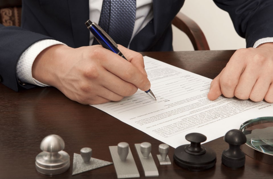 Immigration forms and identification laid out for a notary appointment